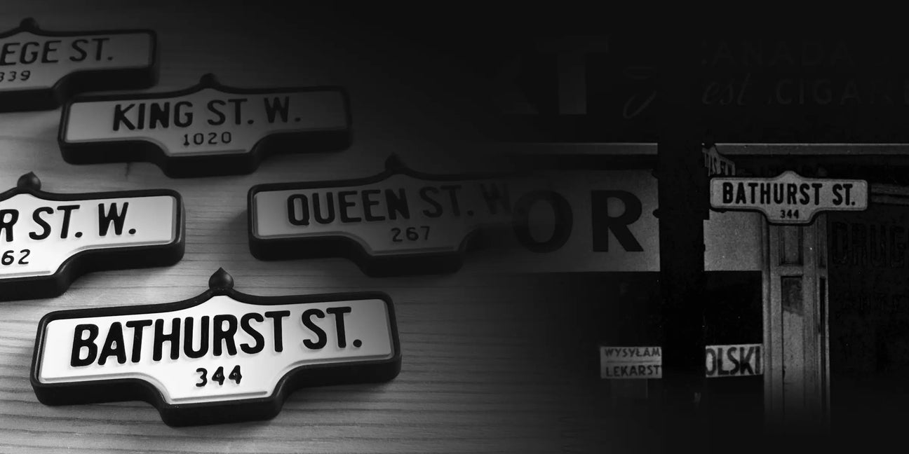 Acorn street signs alongside an archival Toronto black and white photo of a Bathurst St. sign.