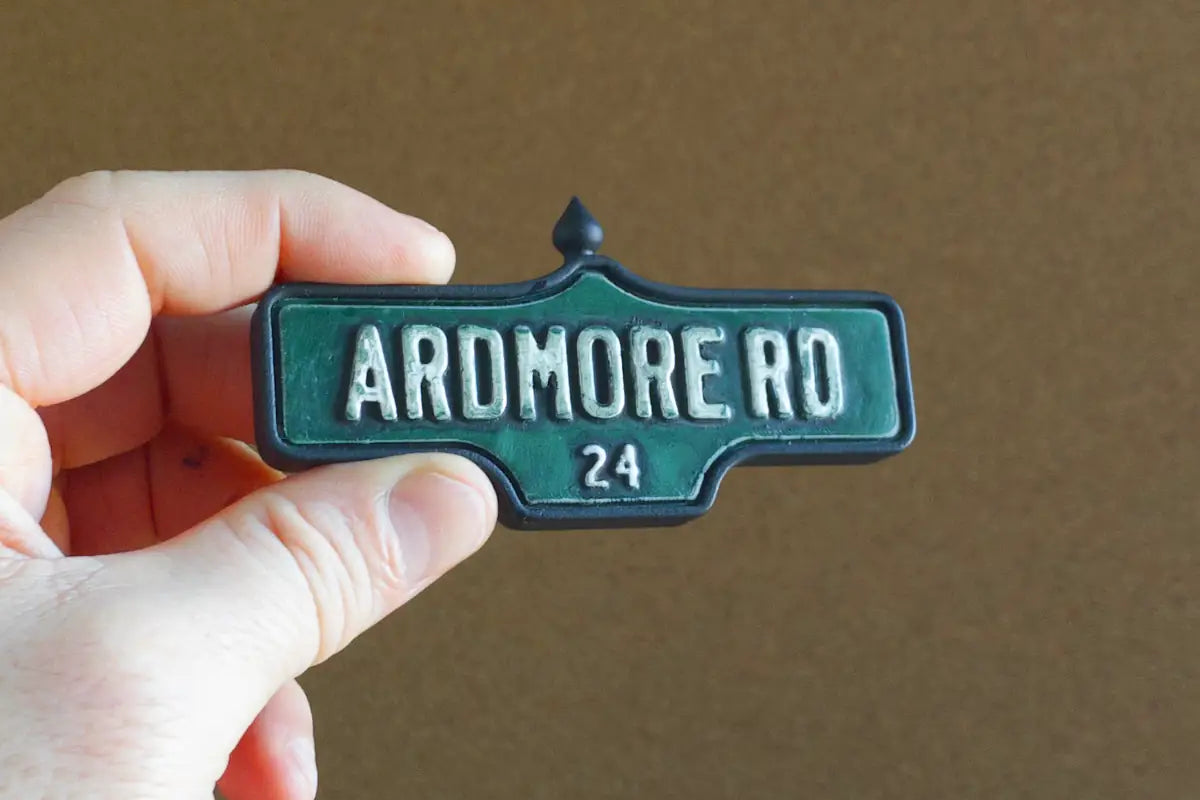 In-hand view of Ardmore Rd. #24 Magnet - Weathered Finish, miniature replica Toronto Forest Hill acorn street sign
