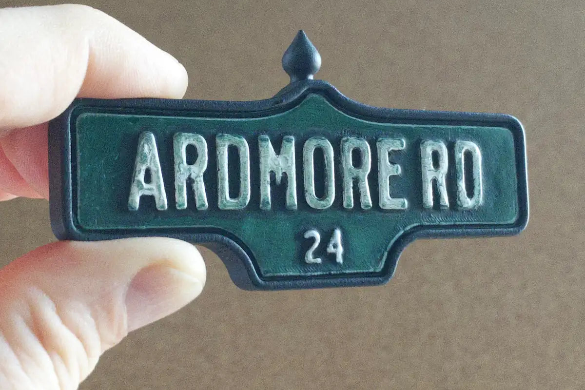 In-hand view of Ardmore Rd. #24 Magnet - Weathered Finish, miniature replica Toronto Forest Hill acorn street sign