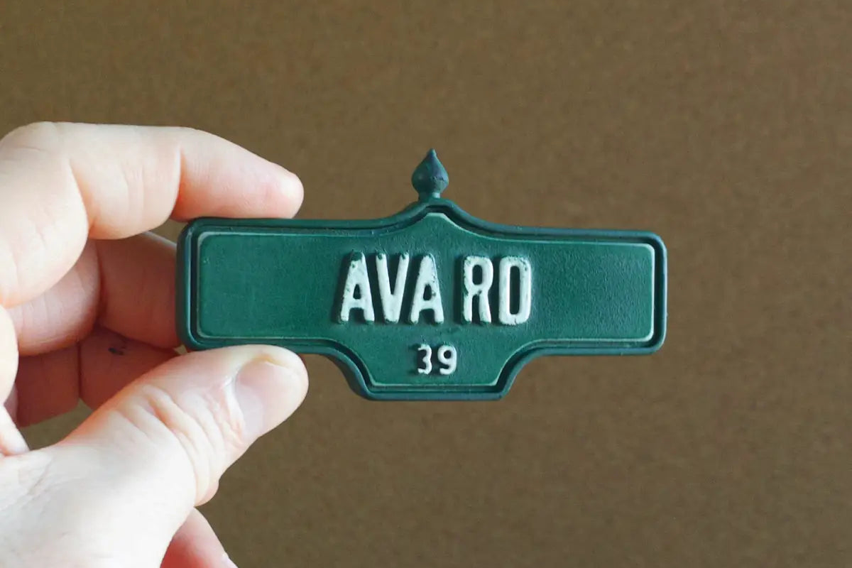 In-hand view of Ava Rd #39 Magnet - Weathered Finish, miniature replica Toronto Forest Hill acorn street sign