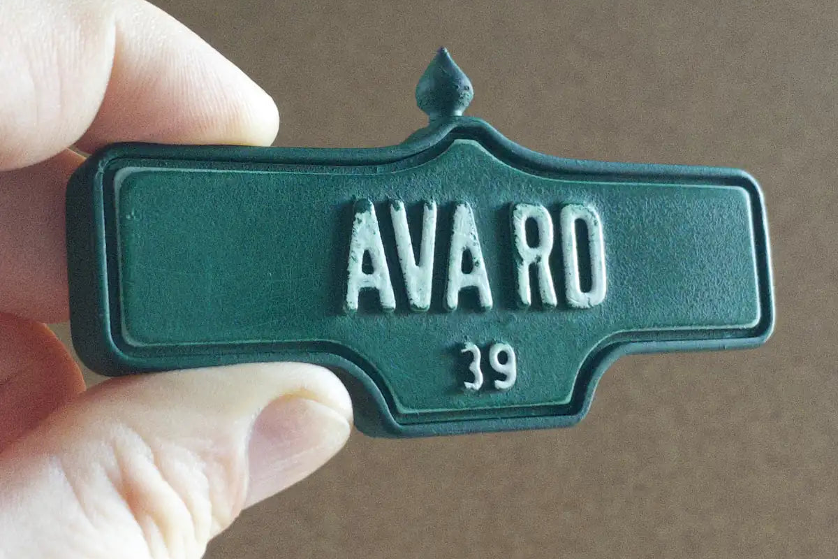 In-hand view of Ava Rd #39 Magnet - Weathered Finish, miniature replica Toronto Forest Hill acorn street sign