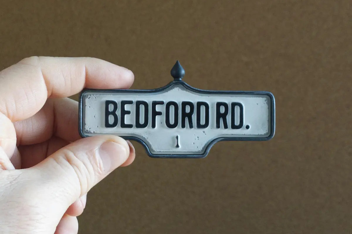 In-hand view of Bedford Rd. #1 - Weathered Finish, miniature replica Toronto acorn street sign