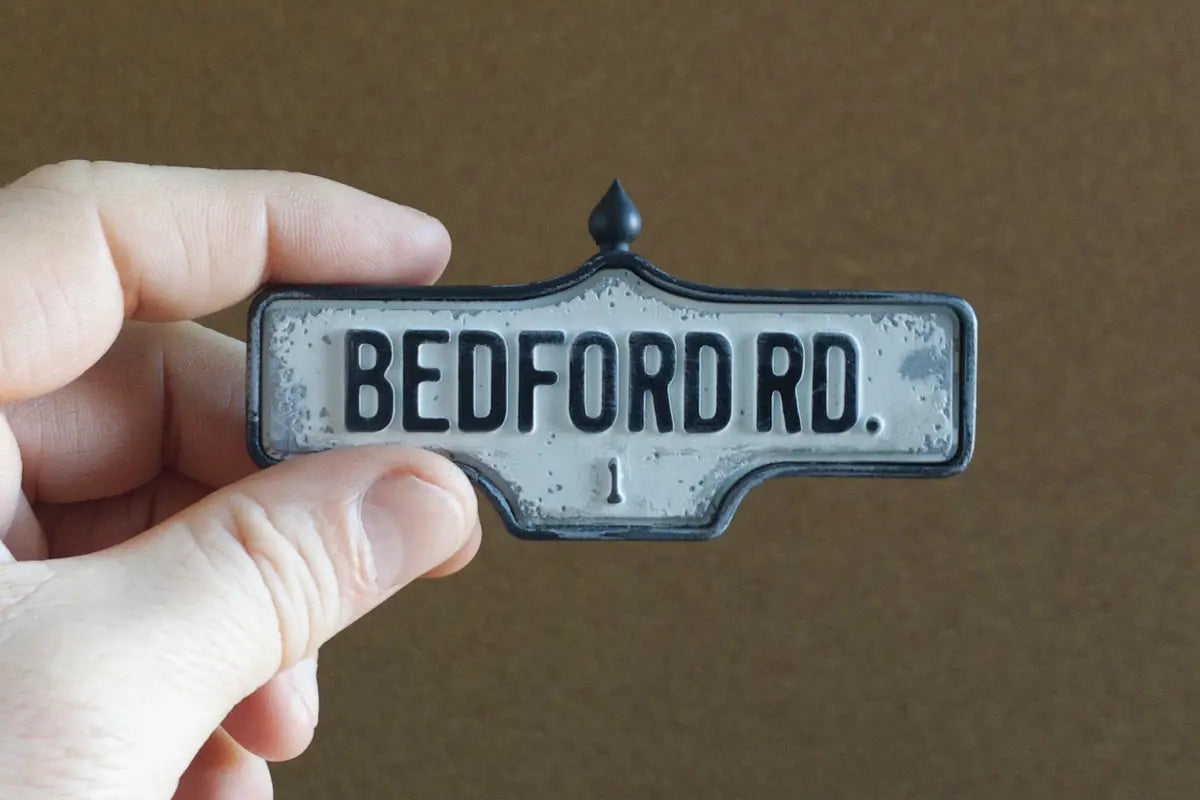 In-hand view of Bedford Rd. #1 - Weathered Finish, miniature replica Toronto acorn street sign