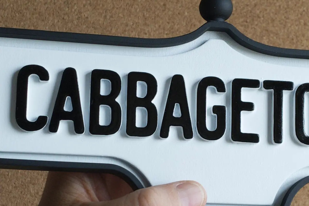 In-hand view of Cabbagetown Wall Sign - Standard Finish, wall-mounted replica Toronto acorn neighbourhood sign