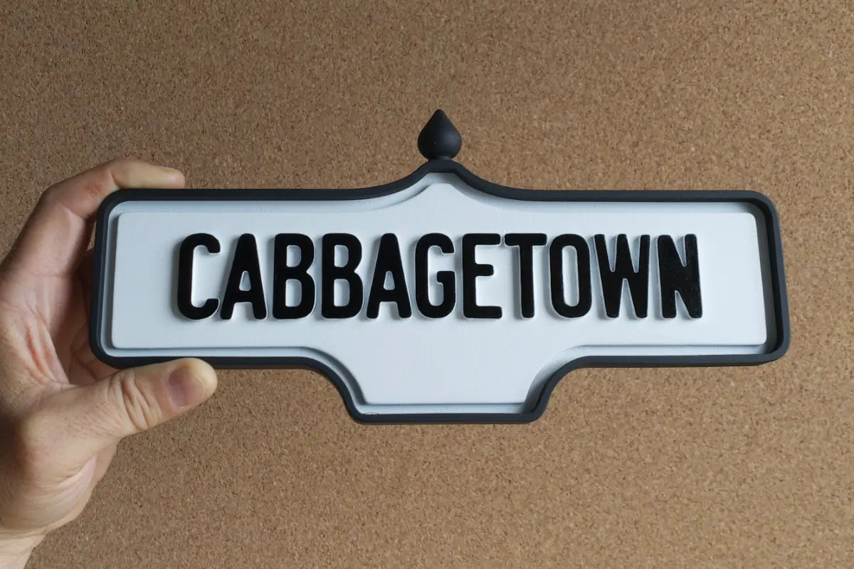 In-hand view of Cabbagetown Wall Sign - Standard Finish, wall-mounted replica Toronto acorn neighbourhood sign