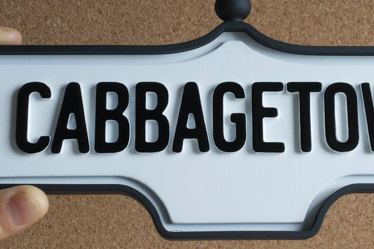 In-hand view of Cabbagetown Wall Sign - Standard Finish, wall-mounted replica Toronto acorn neighbourhood sign