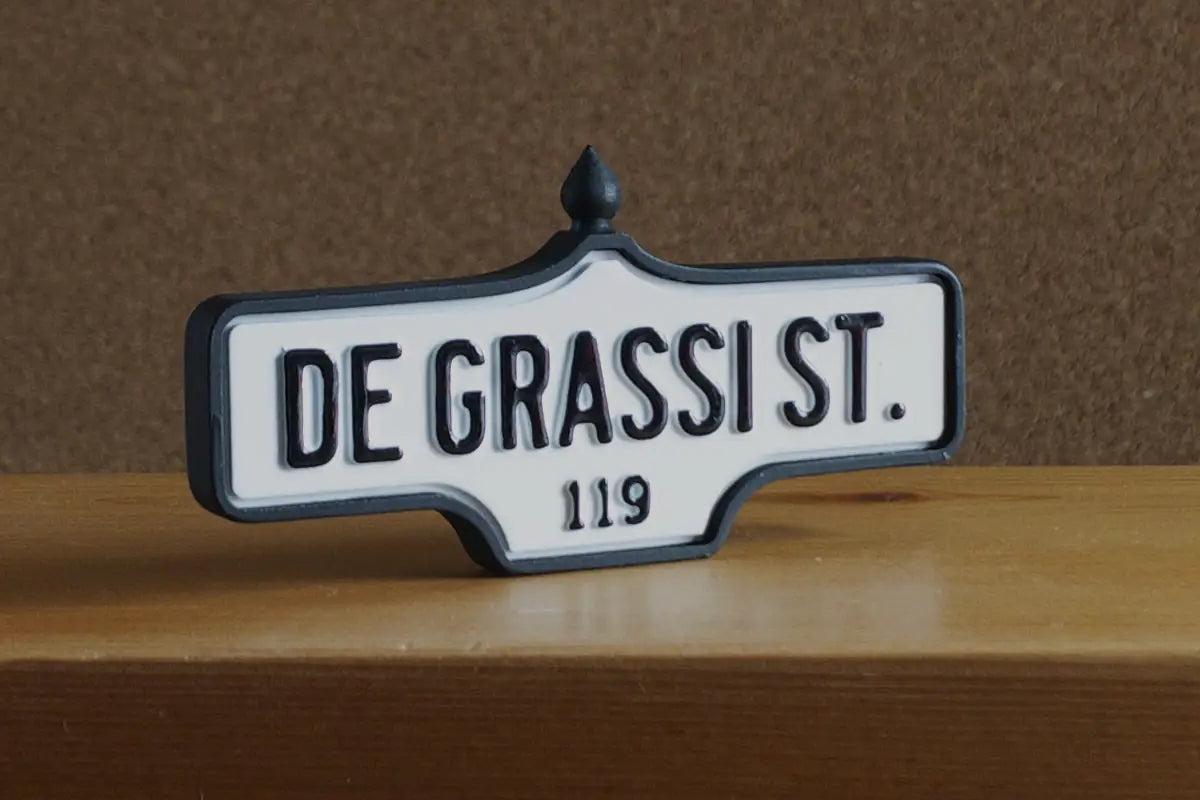 3/4 view of De Grassi St. #119 Pin - Standard Finish, miniature replica Toronto acorn street sign
