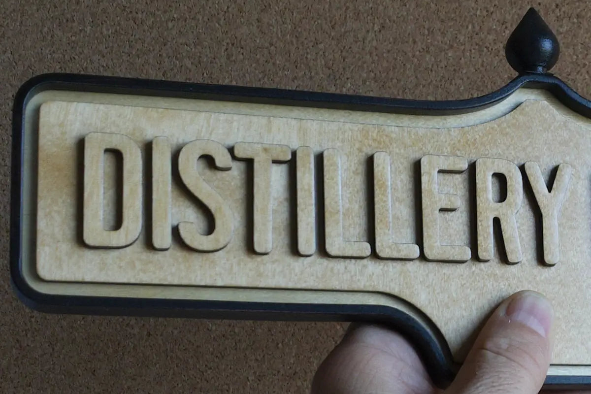 In-hand view of Distillery District Wall Sign - Natural Finish, wall-mounted replica Toronto acorn neighbourhood sign