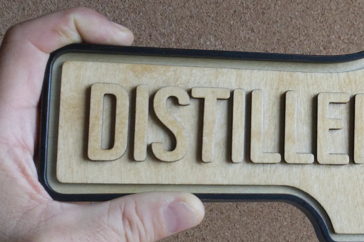 In-hand view of Distillery District Wall Sign - Natural Finish, wall-mounted replica Toronto acorn neighbourhood sign
