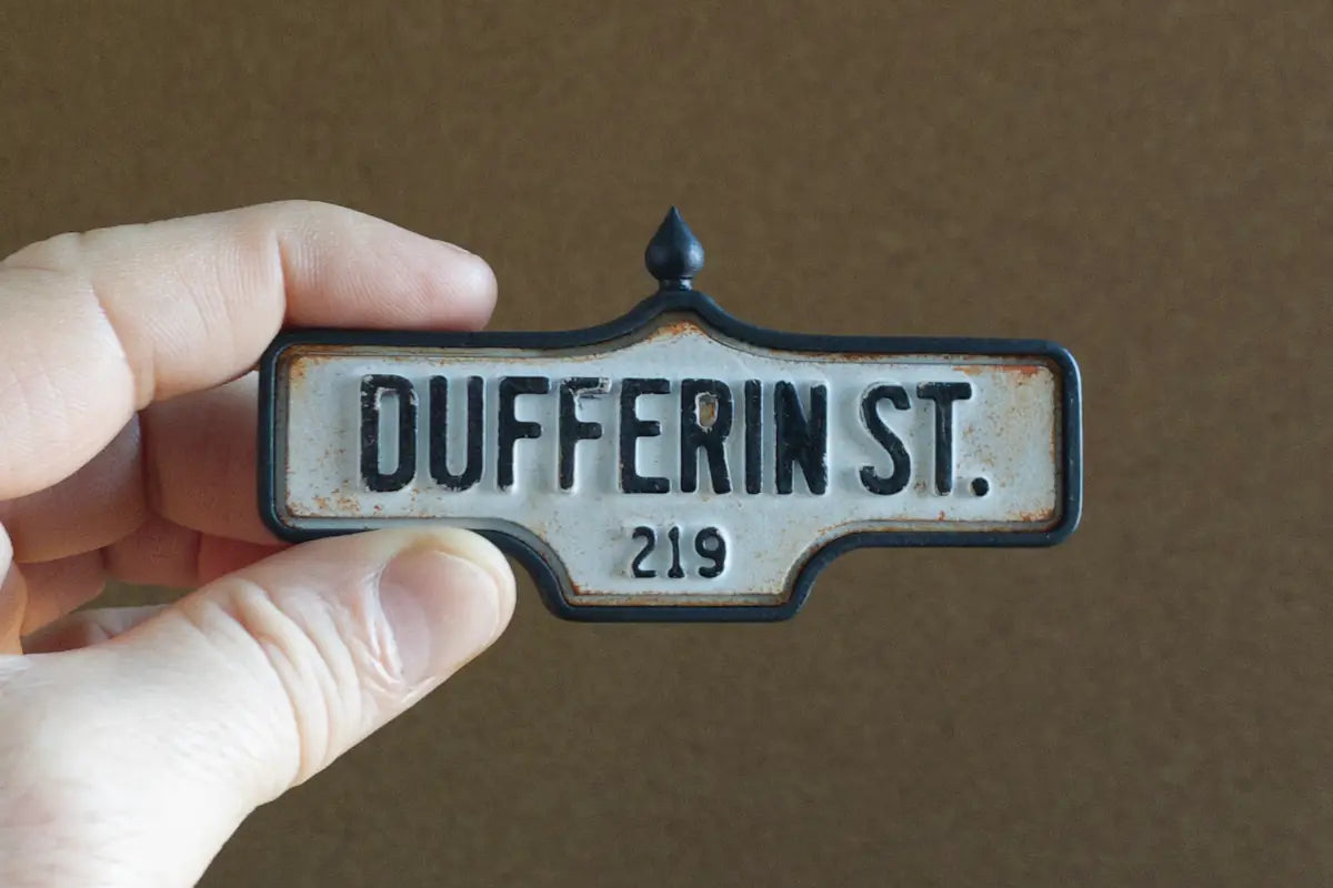 In-hand view of Dufferin St. #219 - Weathered Finish, miniature replica Toronto acorn street sign