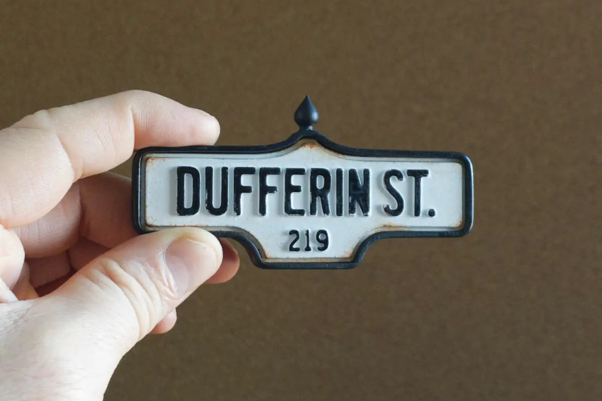 In-hand view of Dufferin St. #219 - Weathered Finish, miniature replica Toronto acorn street sign
