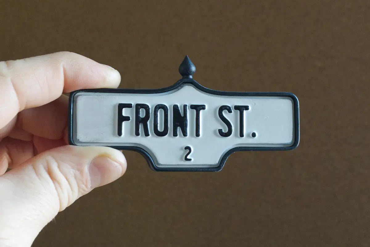 In-hand view of Front St. #2 - Weathered Finish, miniature replica Toronto acorn street sign