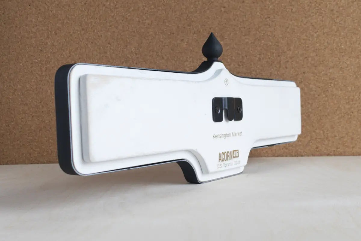 Angled back view of Kensington Market Wall Sign - Standard Finish, wall-mounted replica Toronto acorn neighbourhood sign
