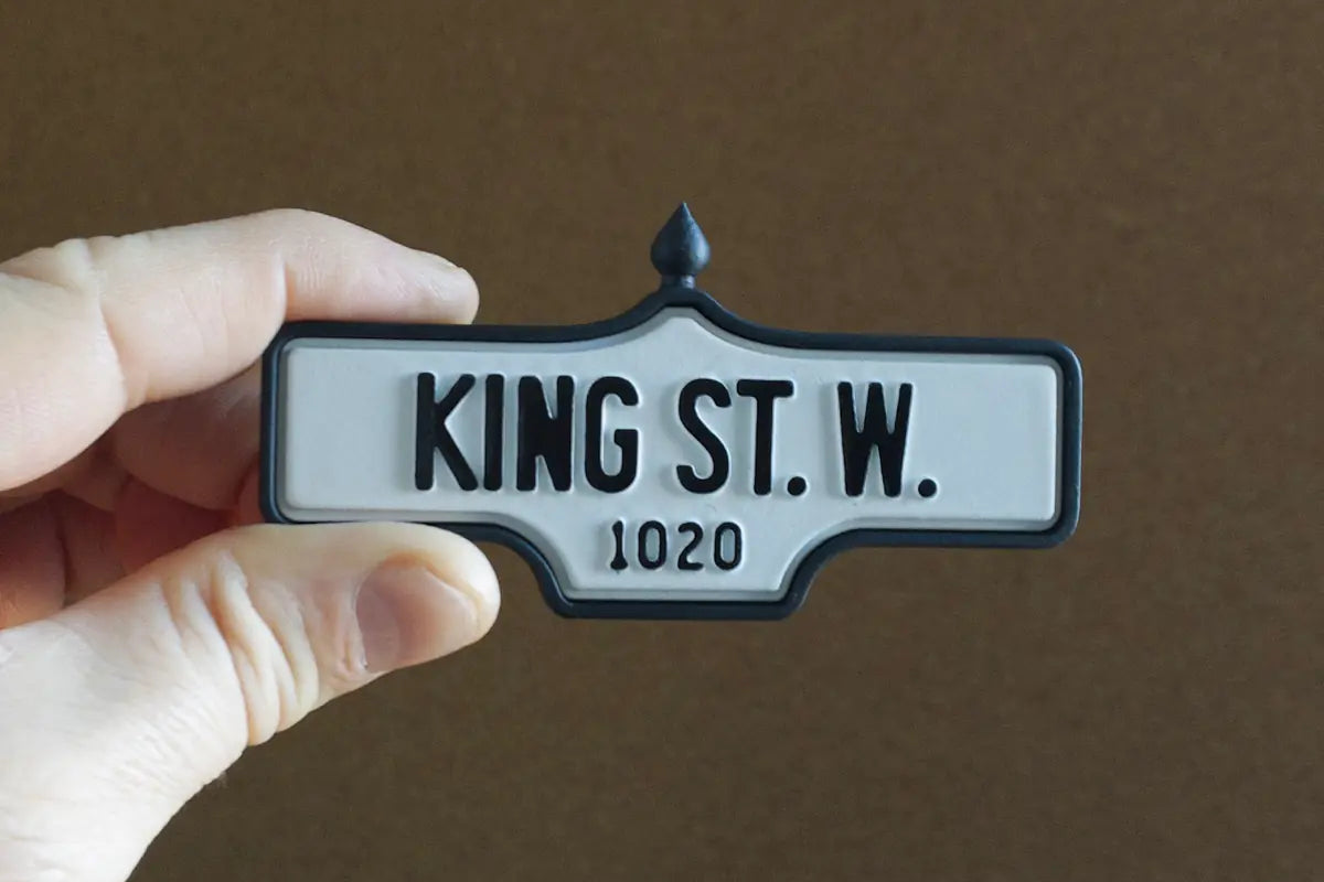 In-hand view of King St. W. #1020 - Standard Finish, miniature replica Toronto acorn street sign