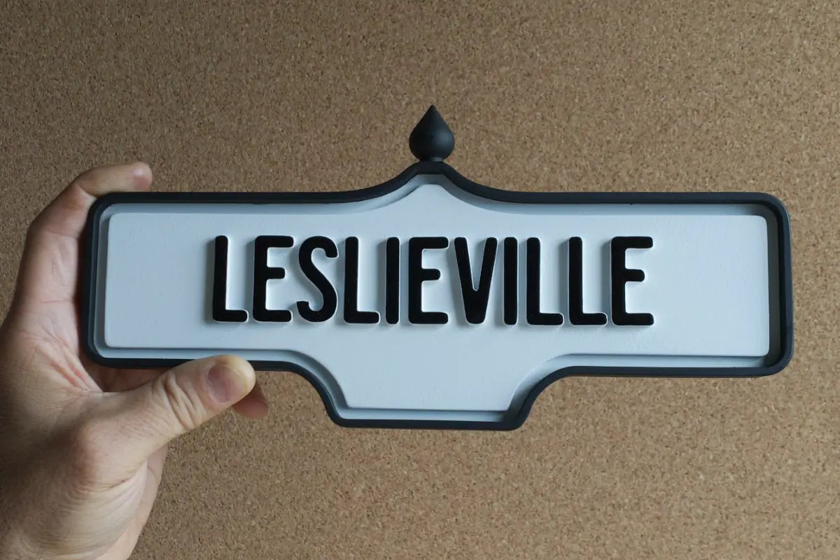 In-hand view of Leslieville Wall Sign - Standard Finish, wall-mounted replica Toronto acorn neighbourhood sign