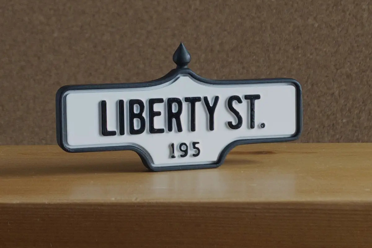 3/4 view of Liberty St. #195 Pin - Standard Finish, miniature replica Toronto acorn street sign