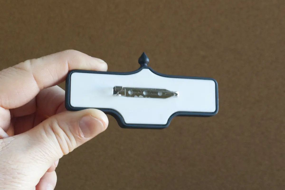 In-hand back view of Liberty St. #195 Pin - Standard Finish, miniature replica Toronto acorn street sign