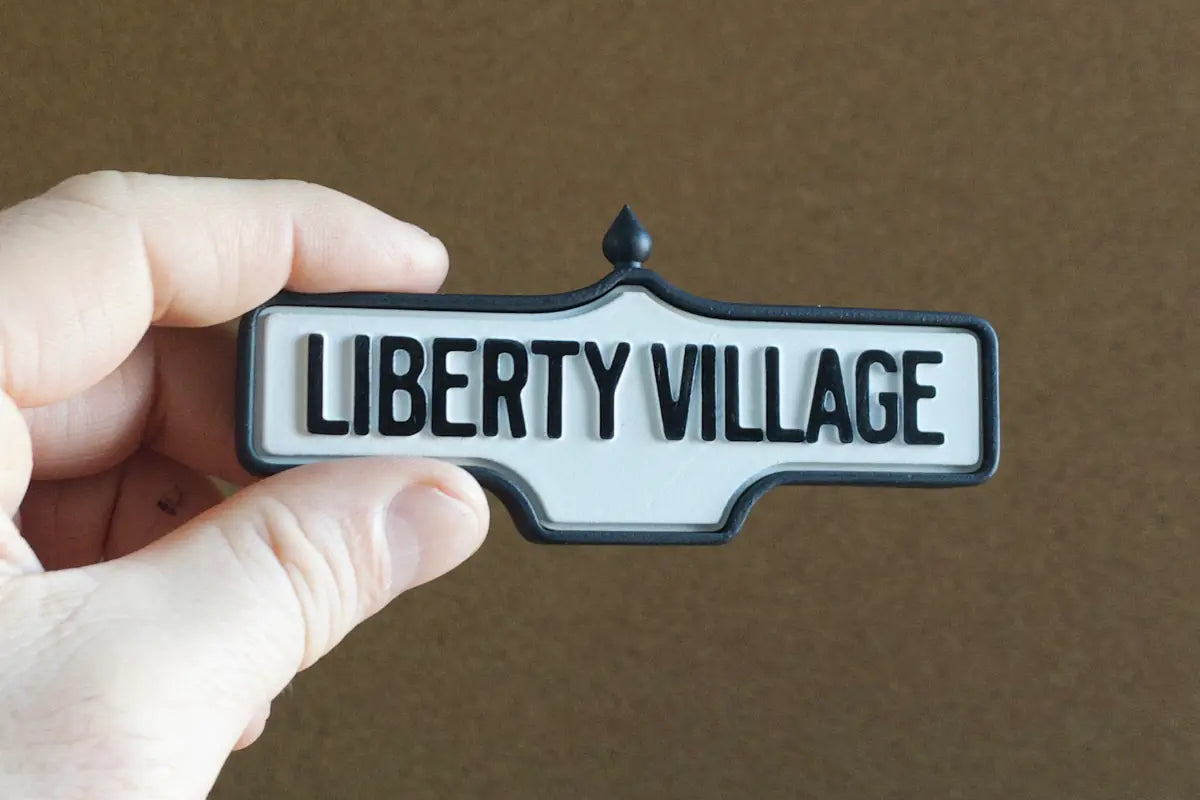 In-hand view of Liberty Village - Standard Finish, miniature replica Toronto neighbourhood acorn street sign
