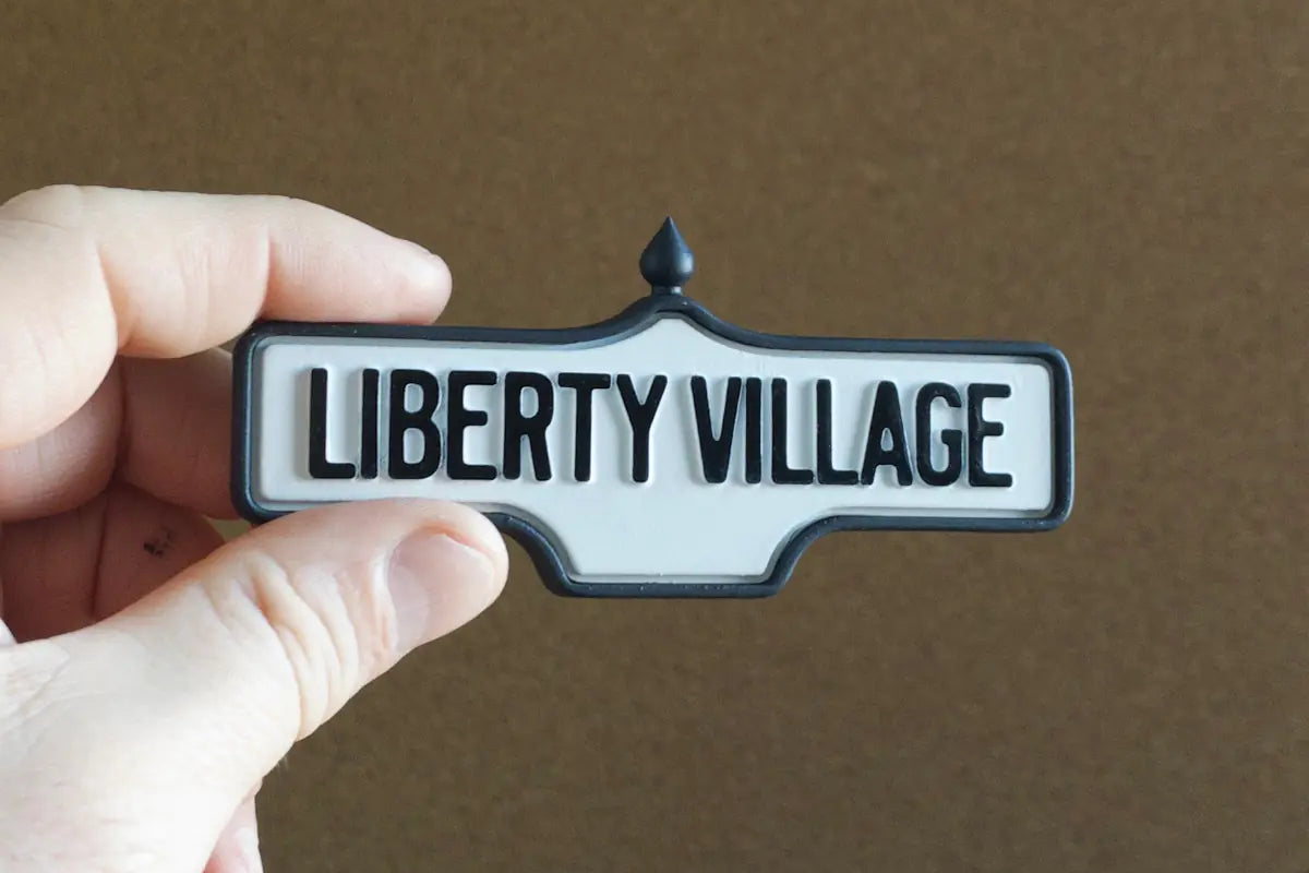 In-hand view of Liberty Village - Standard Finish, miniature replica Toronto neighbourhood acorn street sign