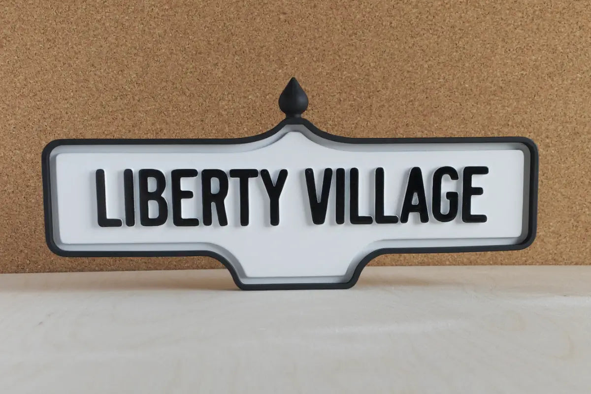 Front view of Liberty Village Wall Sign - Standard Finish, wall-mounted replica Toronto acorn neighbourhood sign