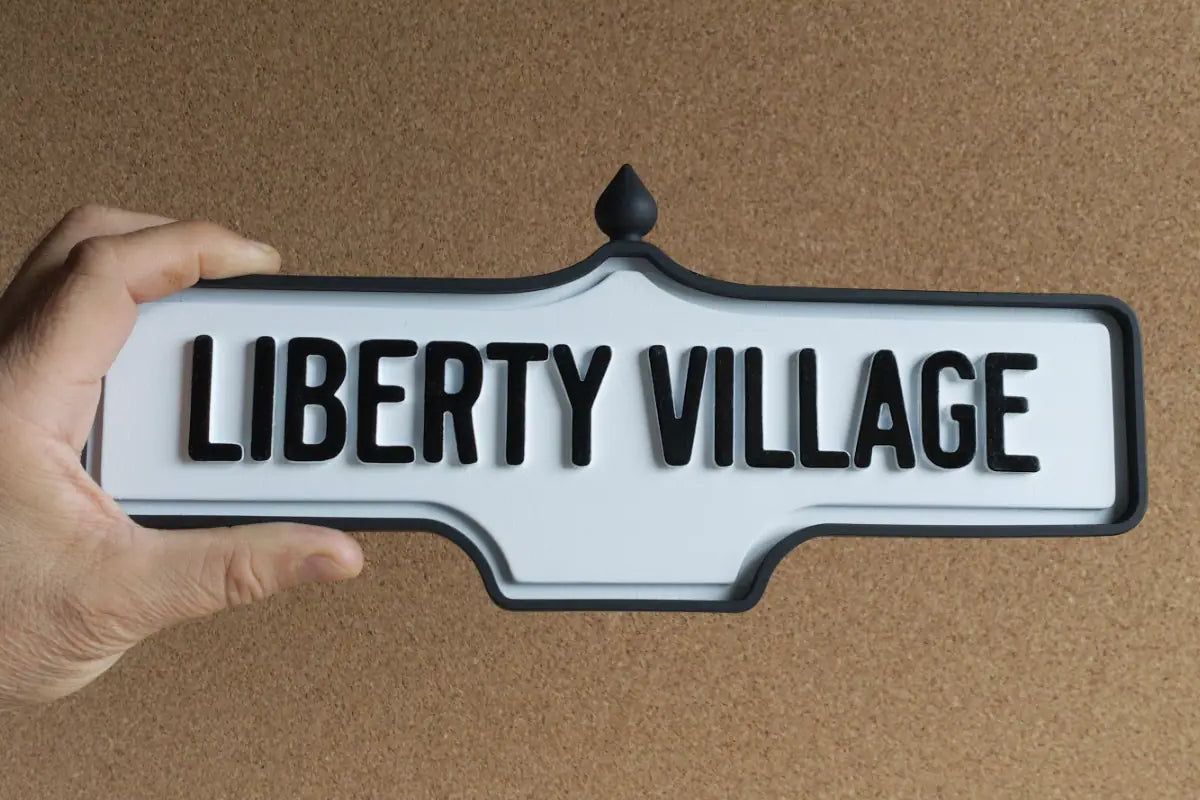 In-hand view of Liberty Village Wall Sign - Standard Finish, wall-mounted replica Toronto acorn neighbourhood sign
