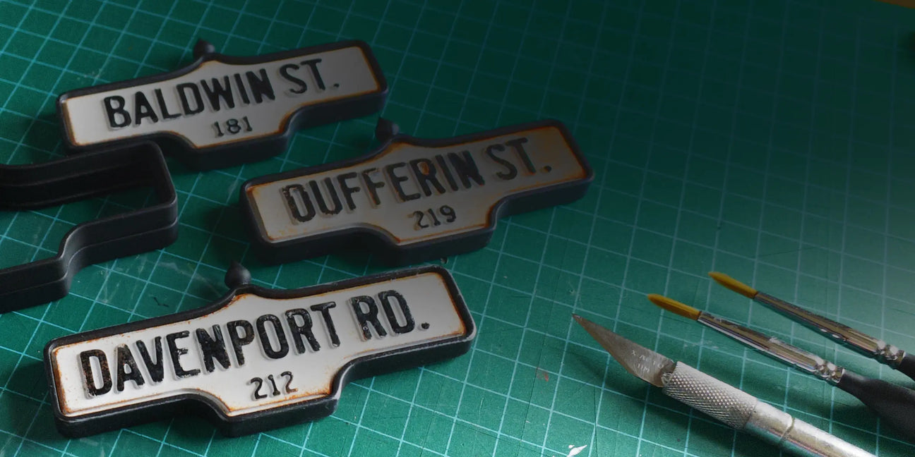 Three acorn street signs: 181 Baldwin St., 219 Dufferin St. and 212 Davenport Rd.