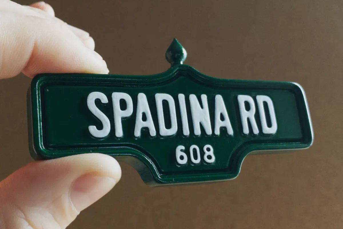 In-hand view of Spadina Rd #608 Magnet - Standard Finish, miniature replica Toronto Forest Hill acorn street sign