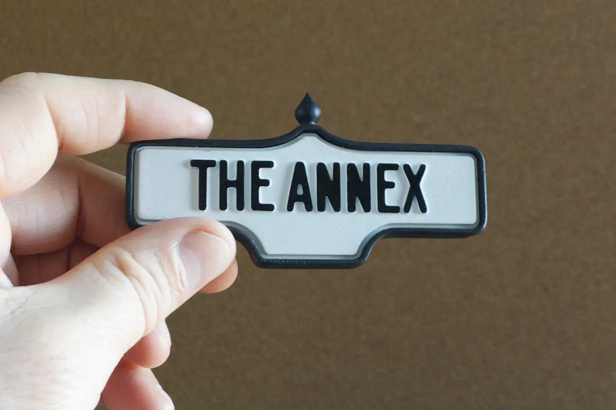 In-hand view of The Annex - Standard Finish I, miniature replica Toronto neighbourhood acorn street sign