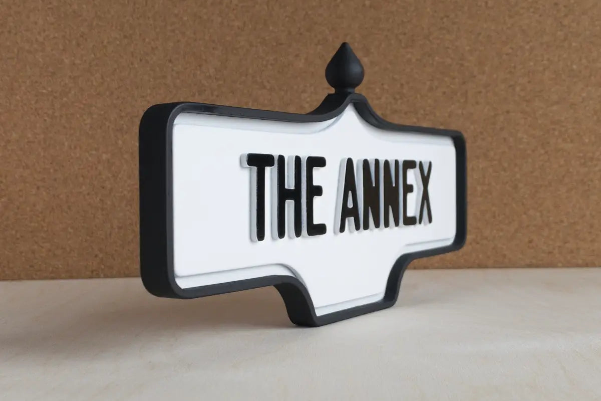 Angled front view of The Annex Wall Sign - Standard Finish, wall-mounted replica Toronto acorn neighbourhood sign