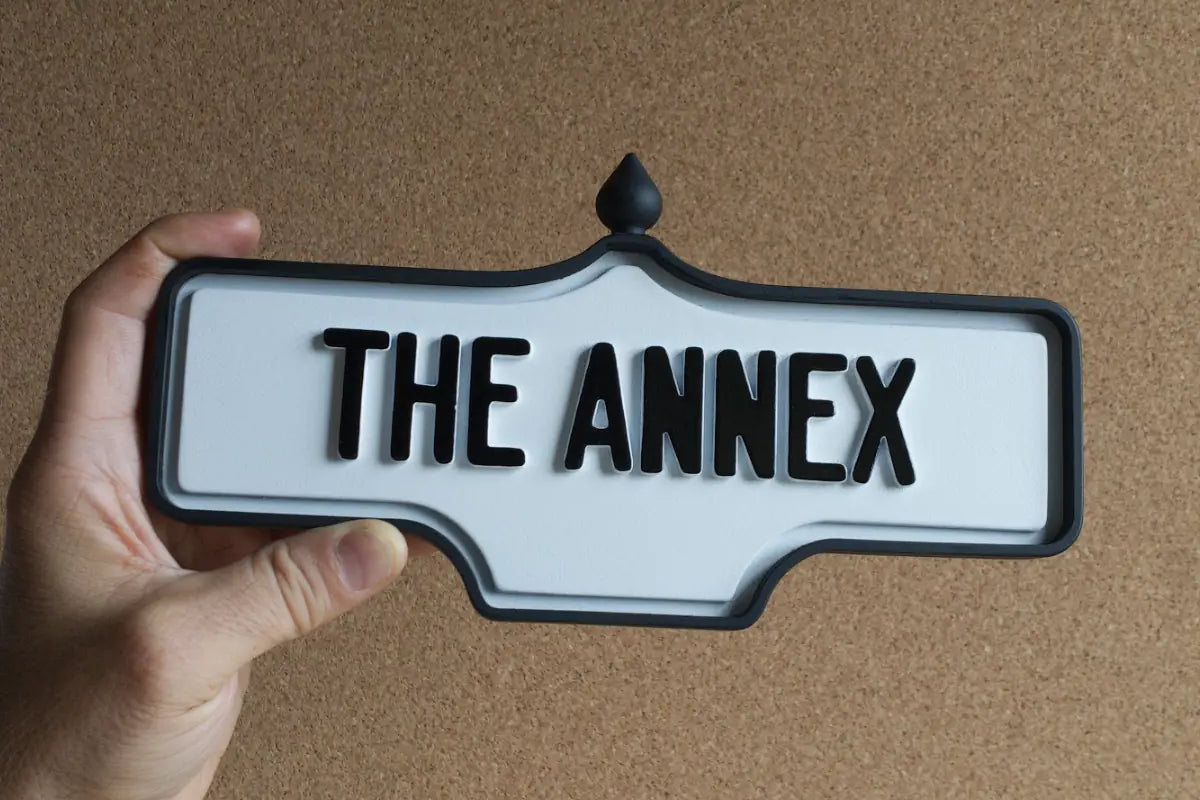 In-hand view of The Annex Wall Sign - Standard Finish, wall-mounted replica Toronto acorn neighbourhood sign