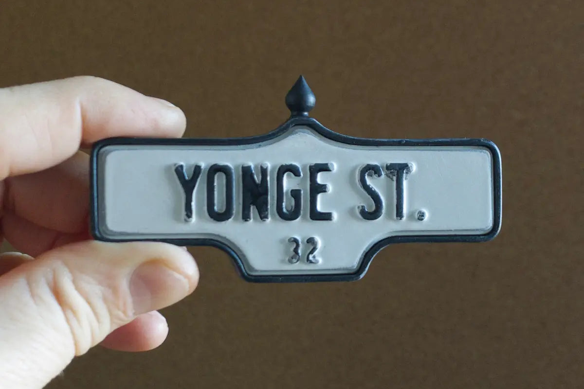 In-hand view of Yonge St. #32 - Weathered Finish I, miniature replica Toronto acorn street sign